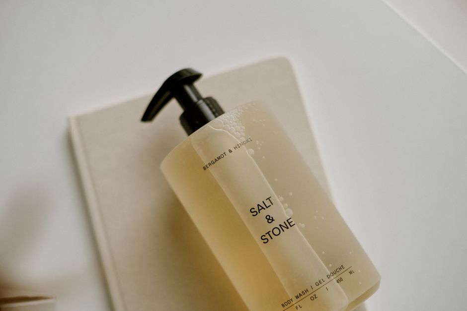 Elegant minimalist photo featuring a beige body wash pump bottle on a soft background.